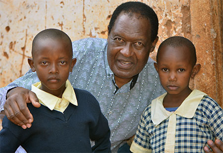 Arthur with two children who have undergone IO