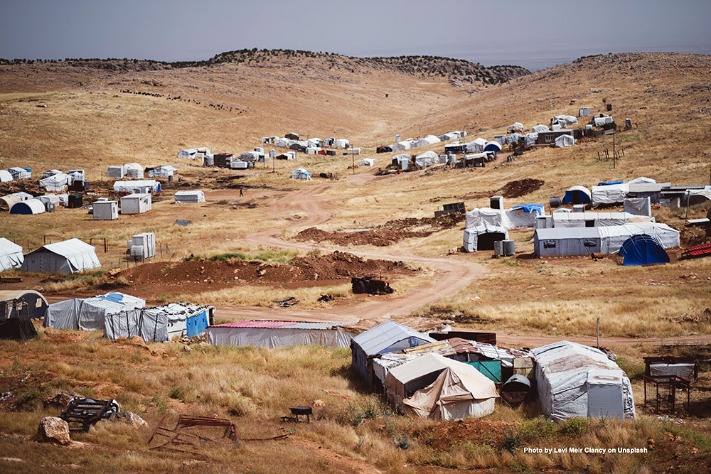 Refugee tents on dirt hillside