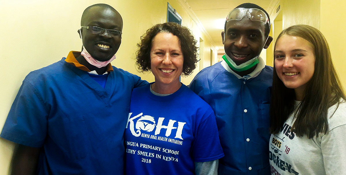 Dr. Kerre and with volunteers at a dental camp.