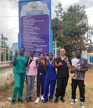 DENTSL652 students Priyanka Prajapati (3rd from left) and Delbert Oxborrow (2nd from right) with study team at Migosi Sub County Hospital.