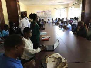 People around a table at 2025 Kisumu Clinic Feedback Meeting Kombewa