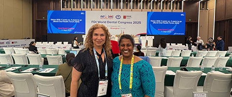 Dr. Seminario with speaker in conference hall.